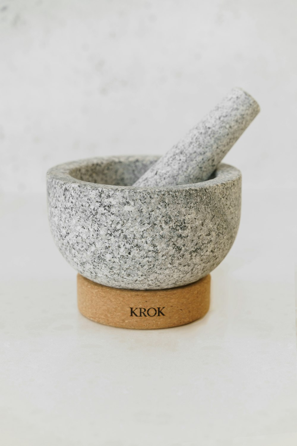 a mortar and pestle set on a white surface
