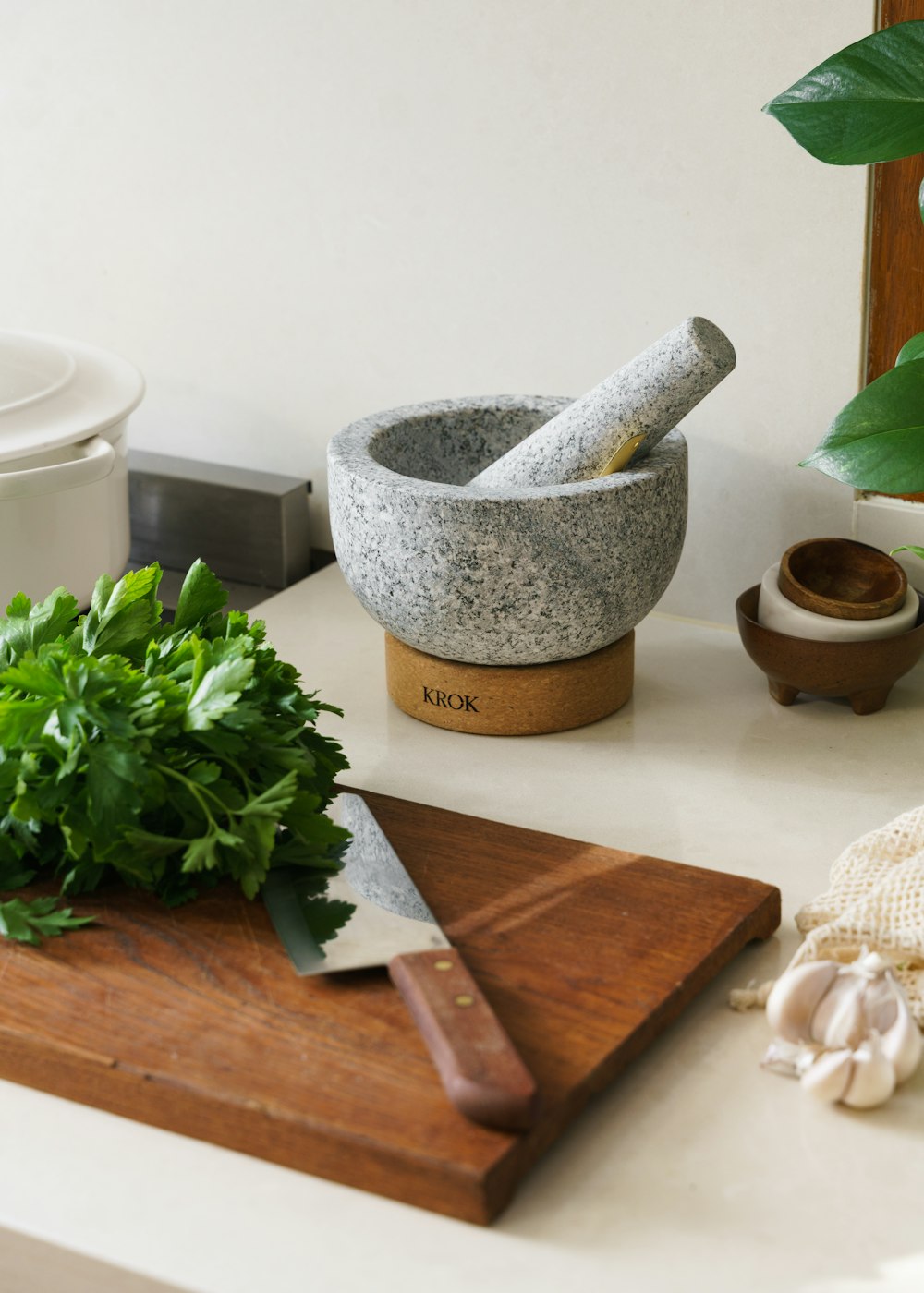 a cutting board with a knife and some parsley on it