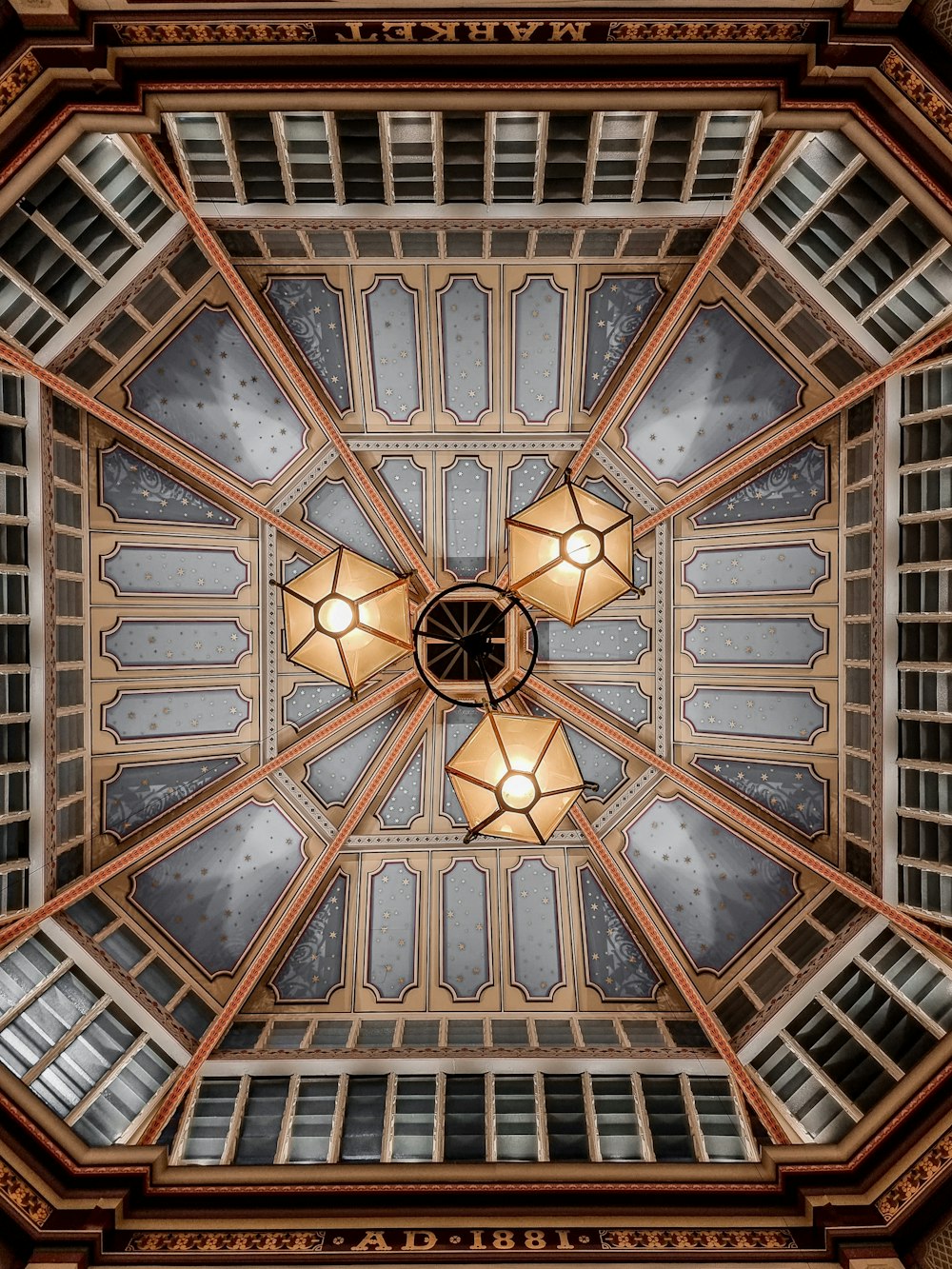 the ceiling of a building with a fancy light fixture