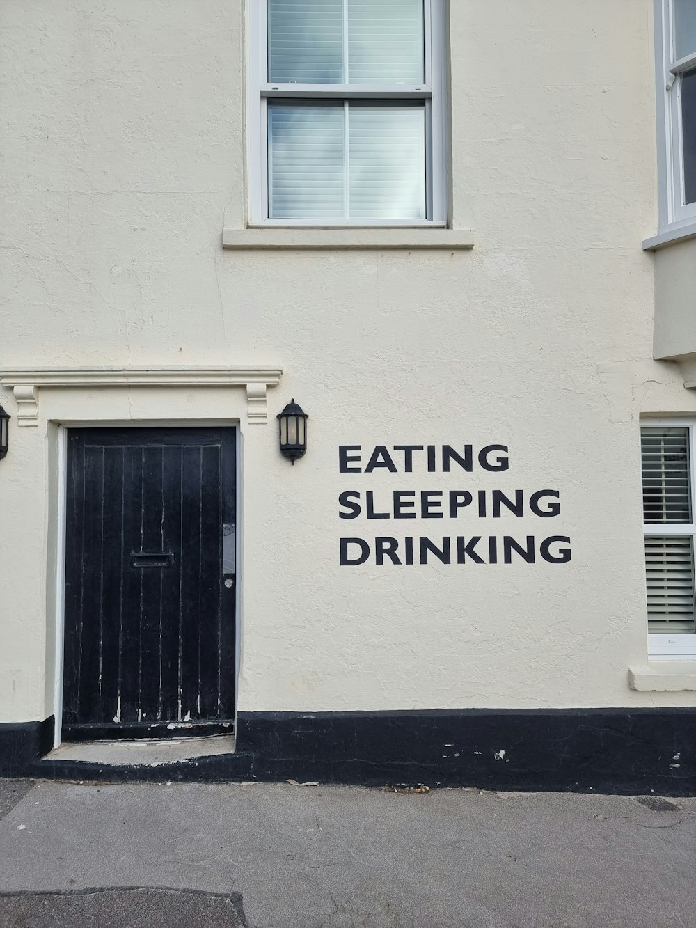 a building with a sign that says eating sleeping drinking
