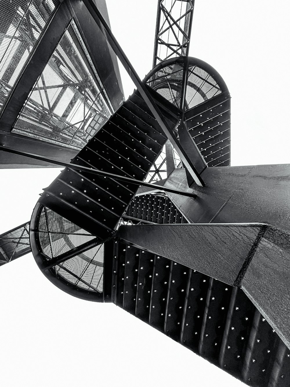 a black and white photo of a spiral staircase