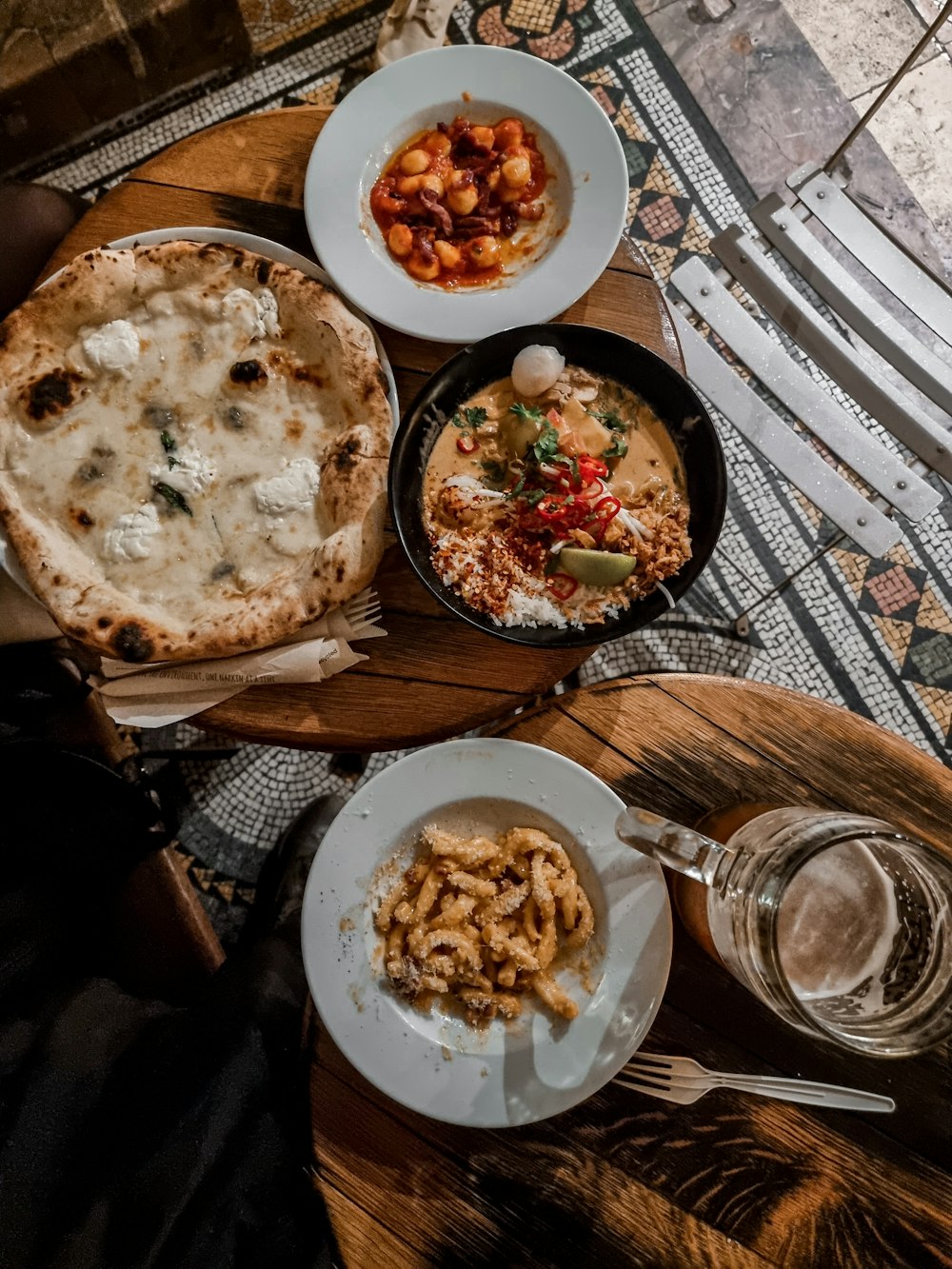 a wooden table topped with plates of food