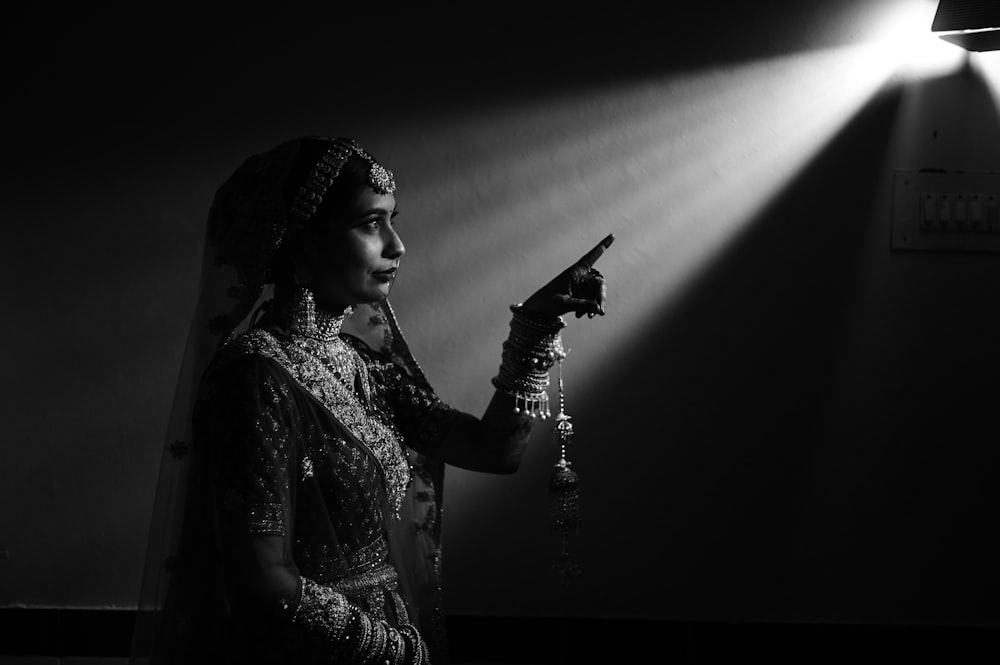 a woman in a bridal gown holding a light