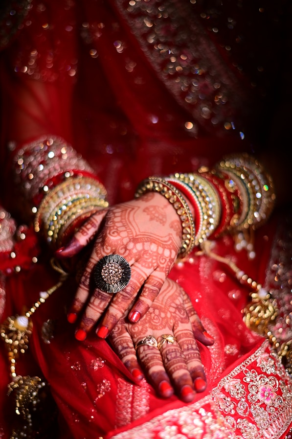 a close up of a woman's hands with hennap