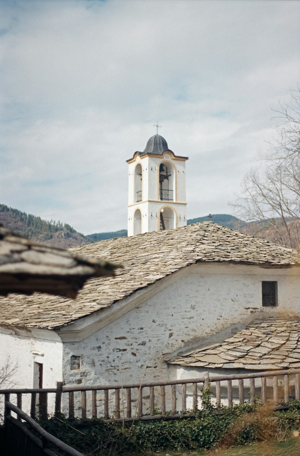 a white building with a bell tower on top of it