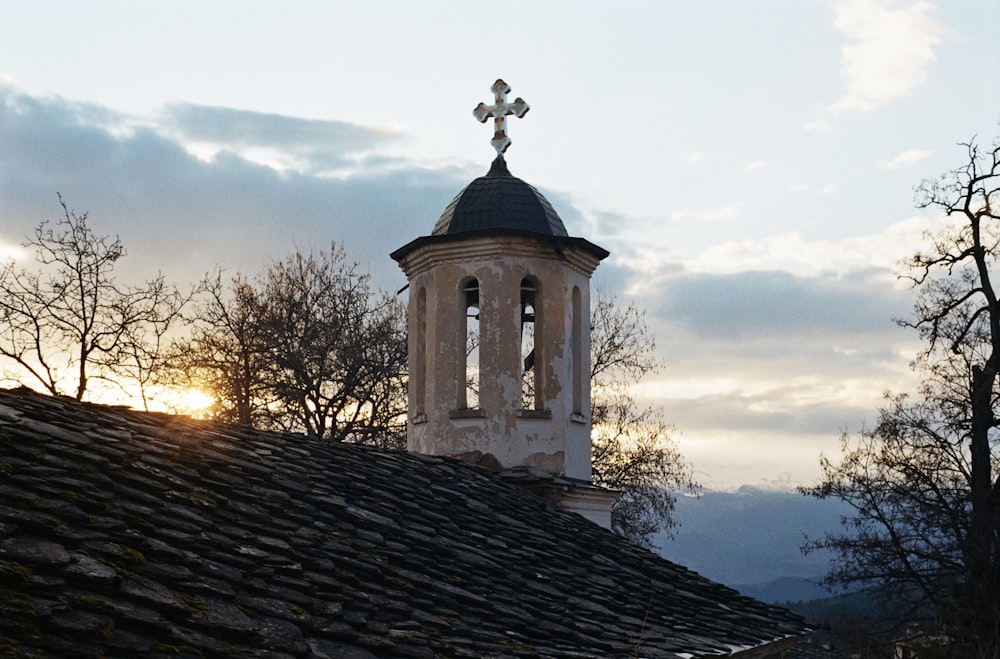 a church steeple with a cross on top of it