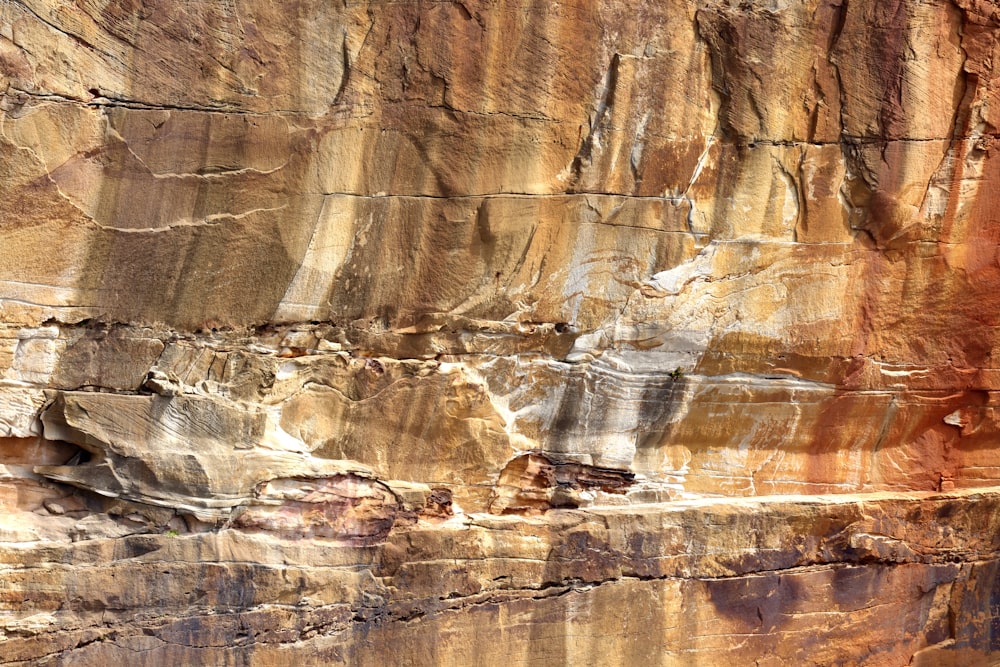 a man riding a horse in front of a cliff