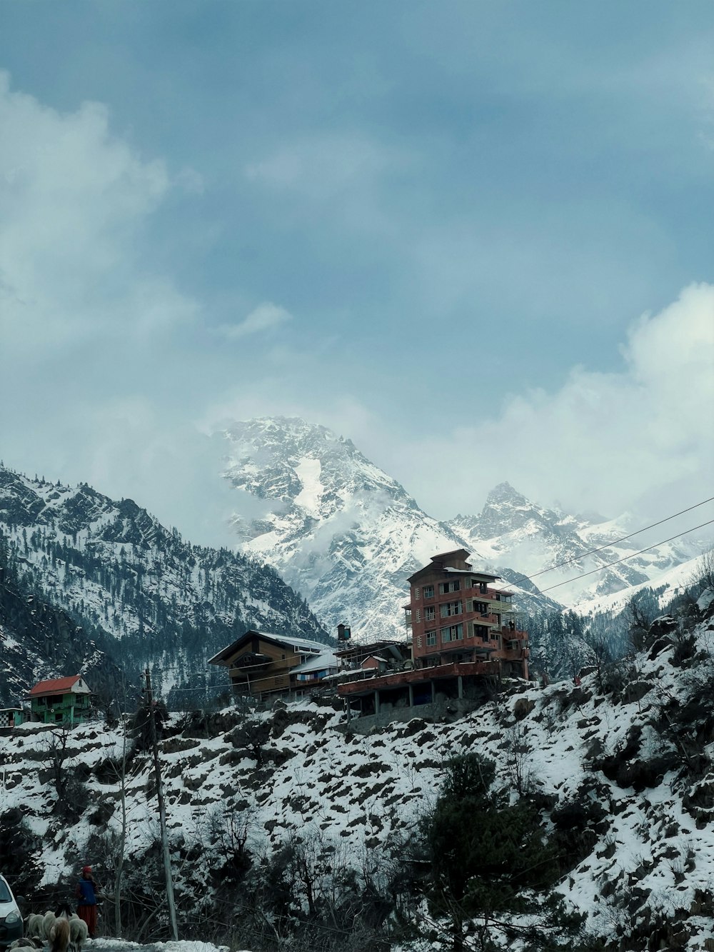 a snowy mountain with a building on top of it