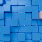 a blue cube with a white block on top of it