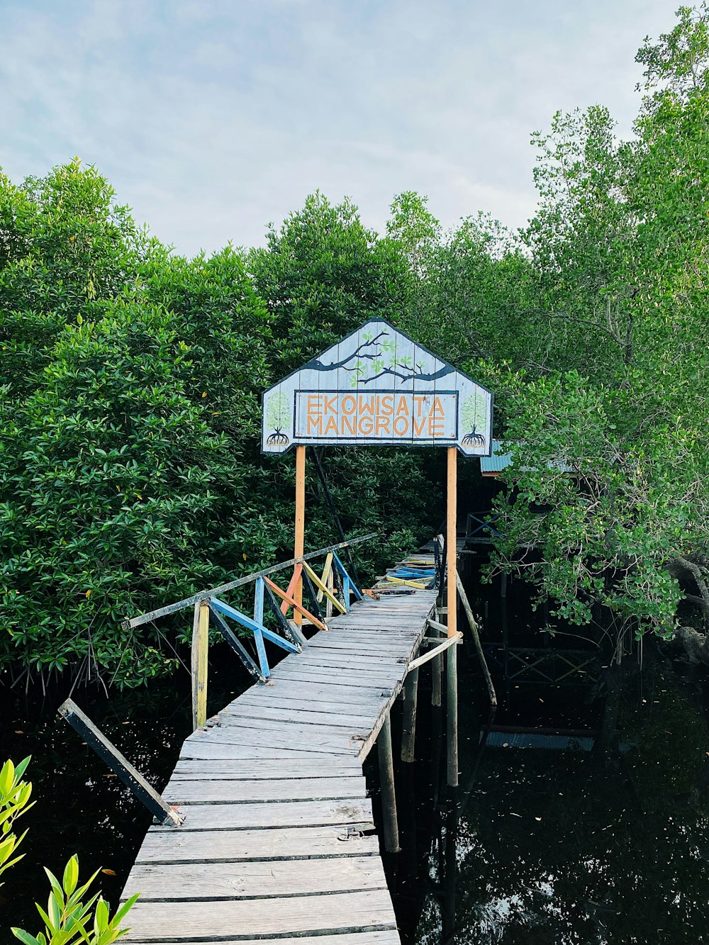 a wooden dock with a sign on it