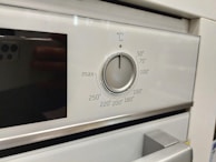a close up of a stove with a knob on it