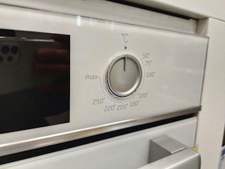 a close up of a stove with a knob on it
