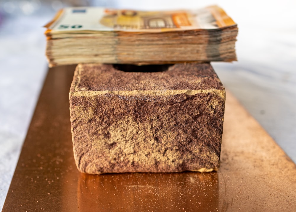 a stack of money sitting on top of a wooden table