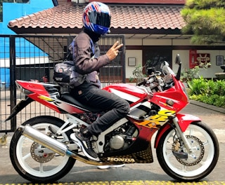 a person sitting on a motorcycle with a helmet on