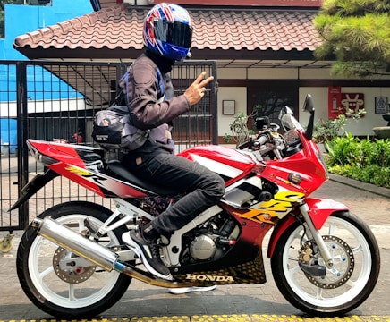 a person sitting on a motorcycle with a helmet on