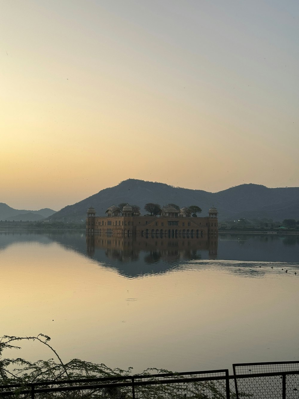 a large building sitting on top of a lake