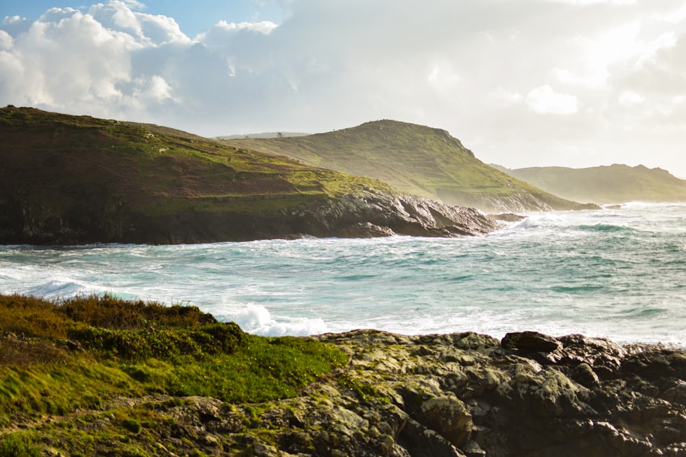 a view of the ocean from a rocky shore