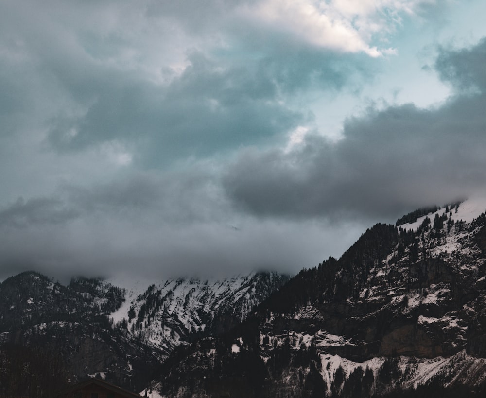 a snowy mountain with a house in the foreground