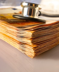 a stack of paper with a stethoscope on top of it