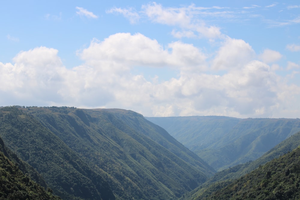 a view of a valley with mountains in the background