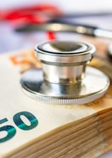 a stethoscope on top of a 50 euro bill