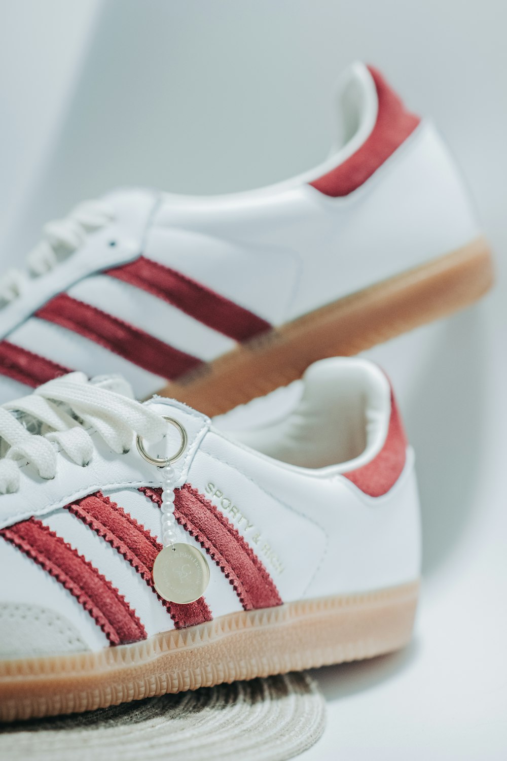 a pair of white and red adidas sneakers
