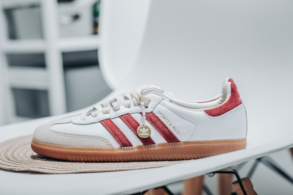 a pair of white and red adidas sneakers