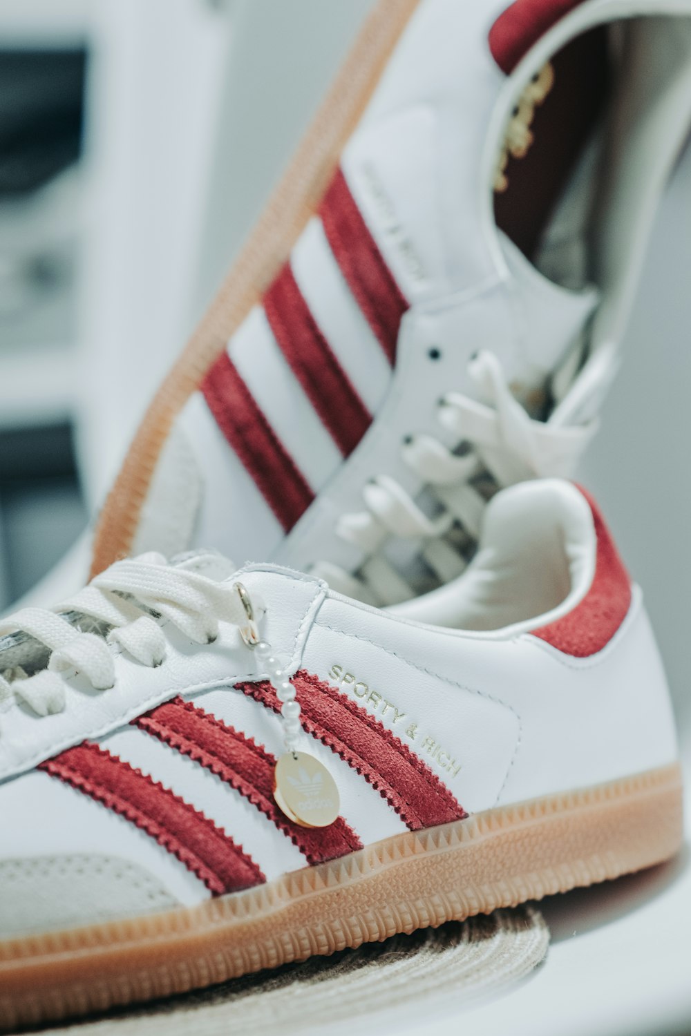 a pair of white and red sneakers sitting on top of a table