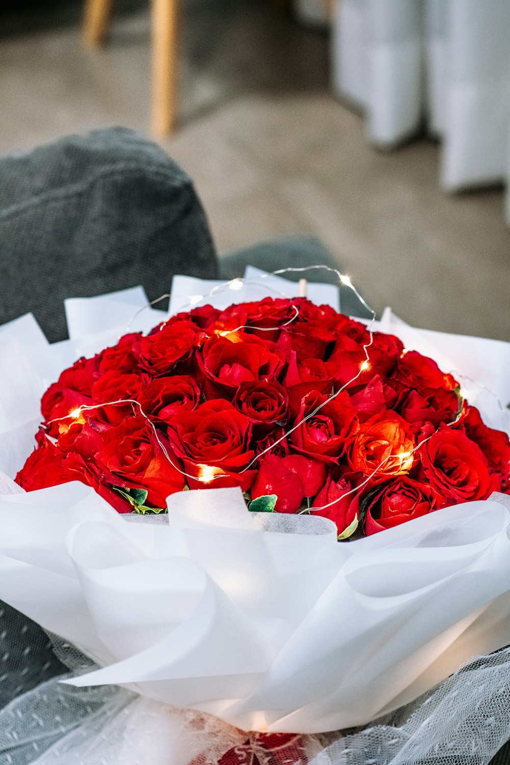 a bouquet of red roses sitting on top of a couch