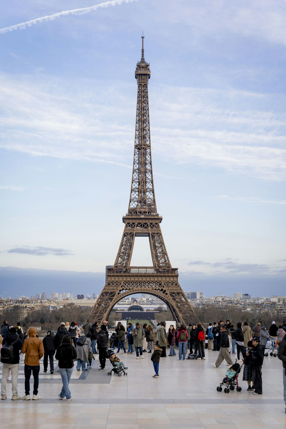 a group of people standing in front of the eiffel tower