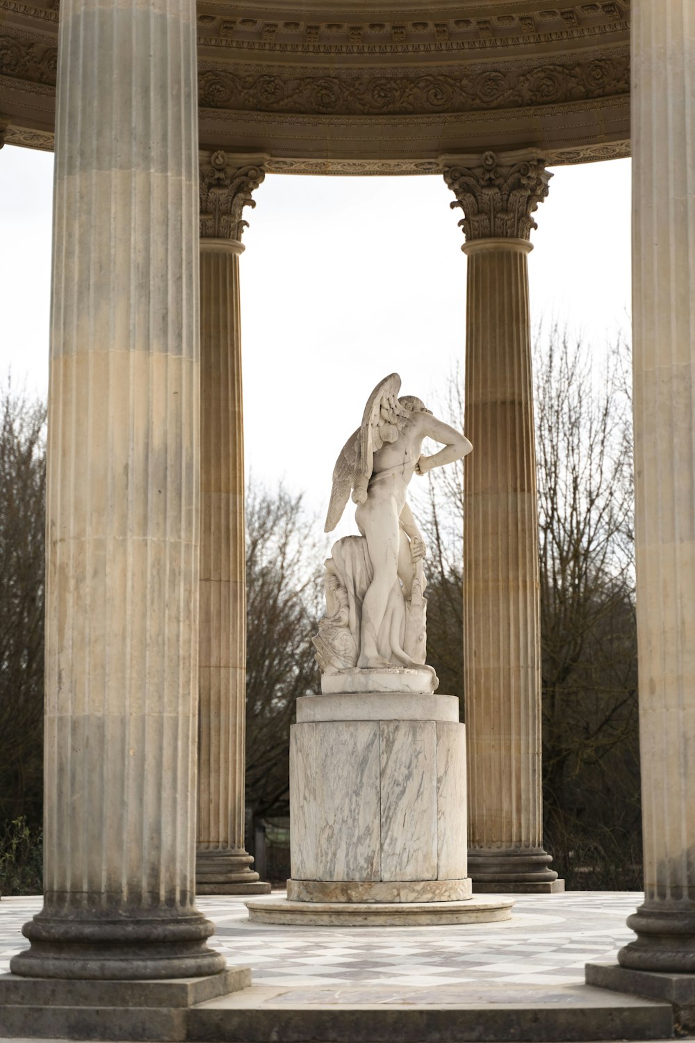 a statue of a winged angel on a pedestal