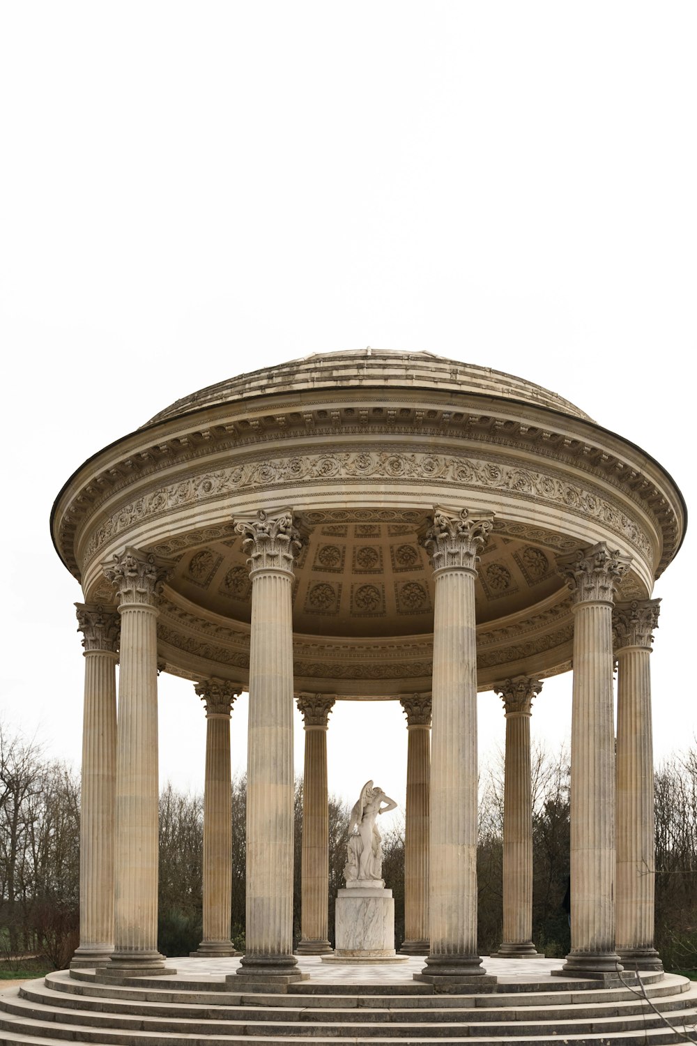 a gazebo with a statue in the middle of it