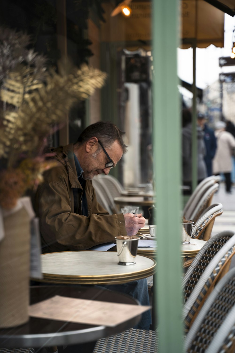 a man sitting at a table with a cup of coffee