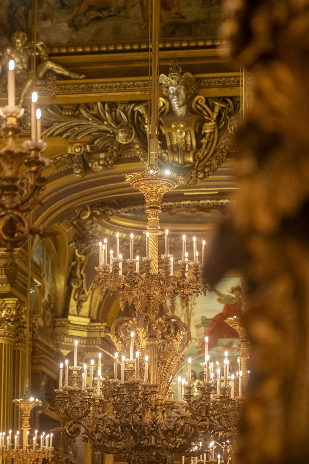 a chandelier in a church with a lot of candles