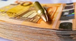 a pen sitting on top of a stack of money