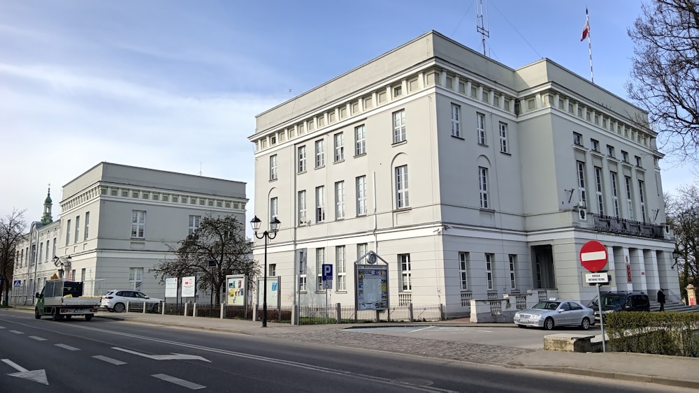 a large white building sitting on the side of a road