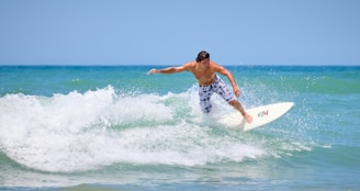 a man riding a wave on top of a surfboard