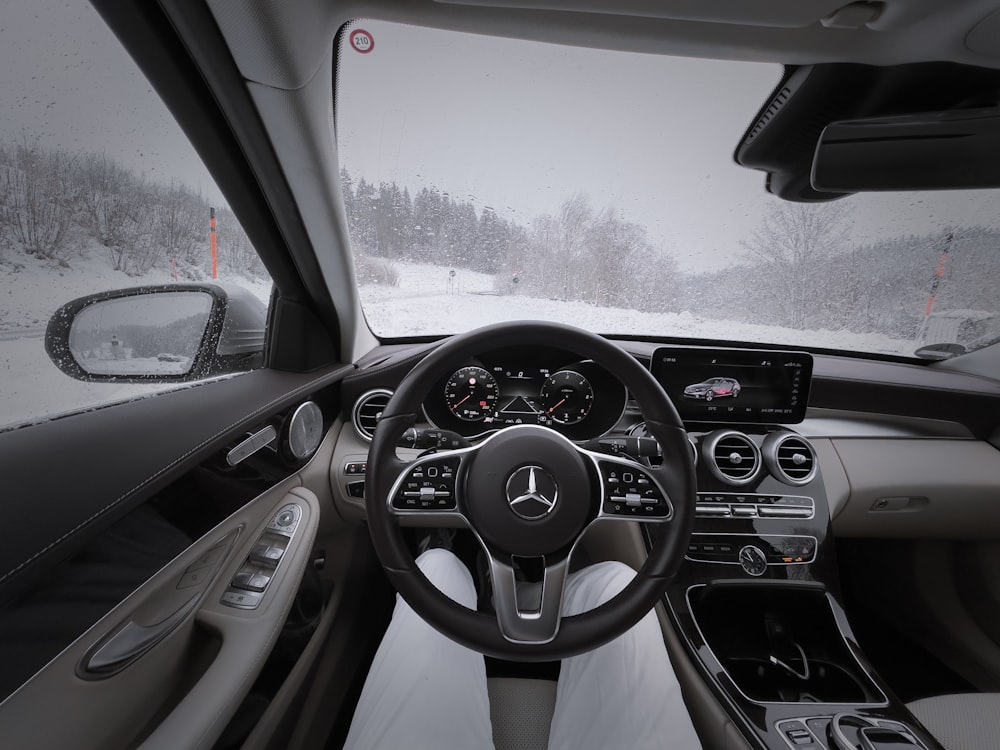 a car driving down a snow covered road