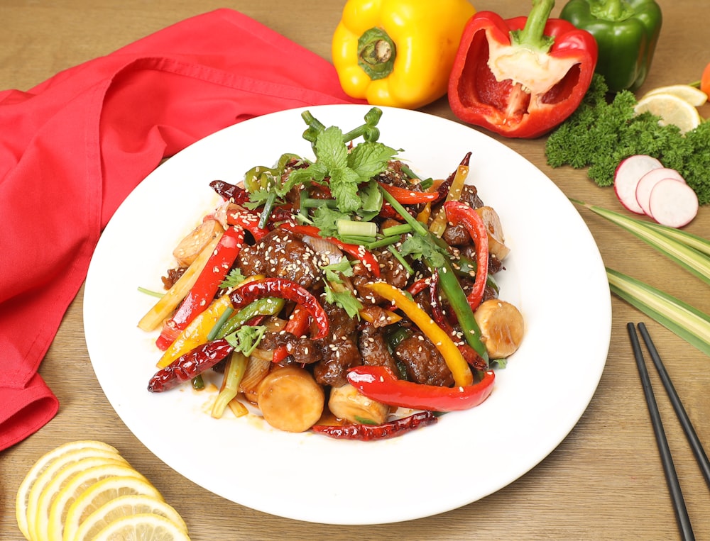 a white plate topped with meat and veggies