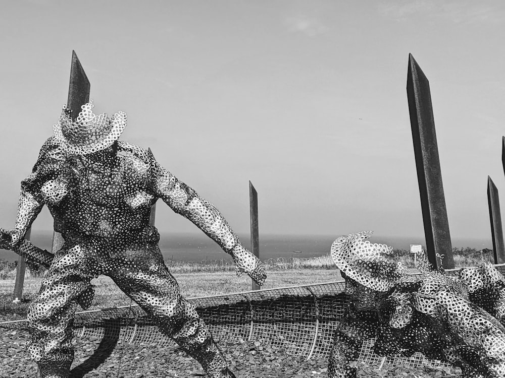 a couple of people standing next to each other near a fence