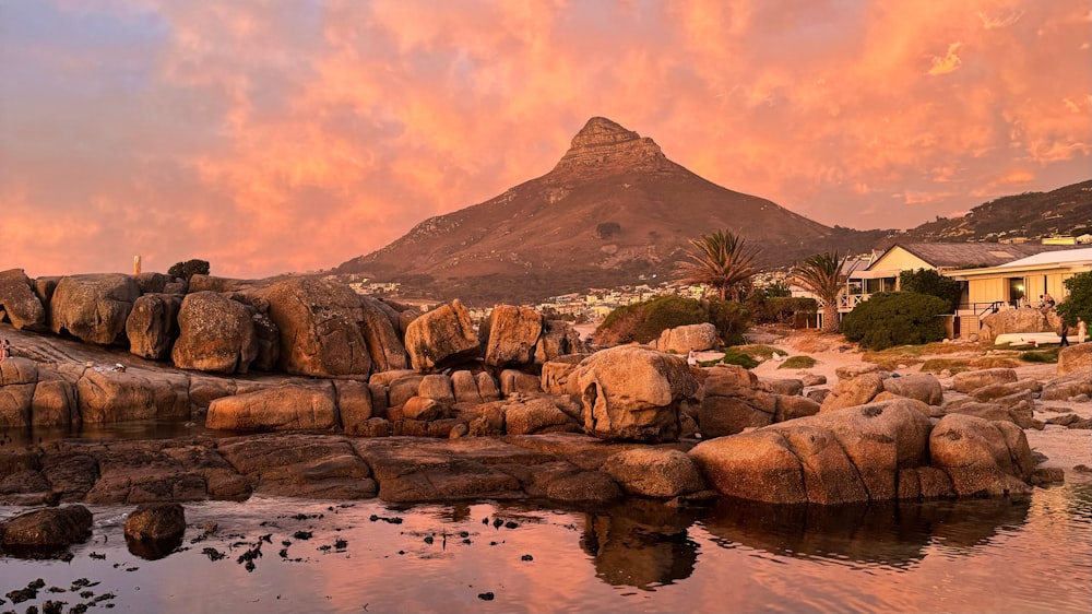 a rocky beach with a mountain in the background