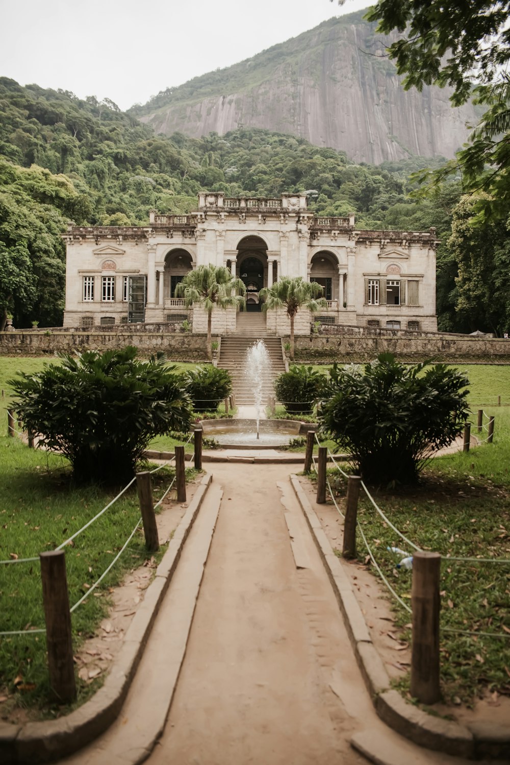 a large white building with a fountain in front of it