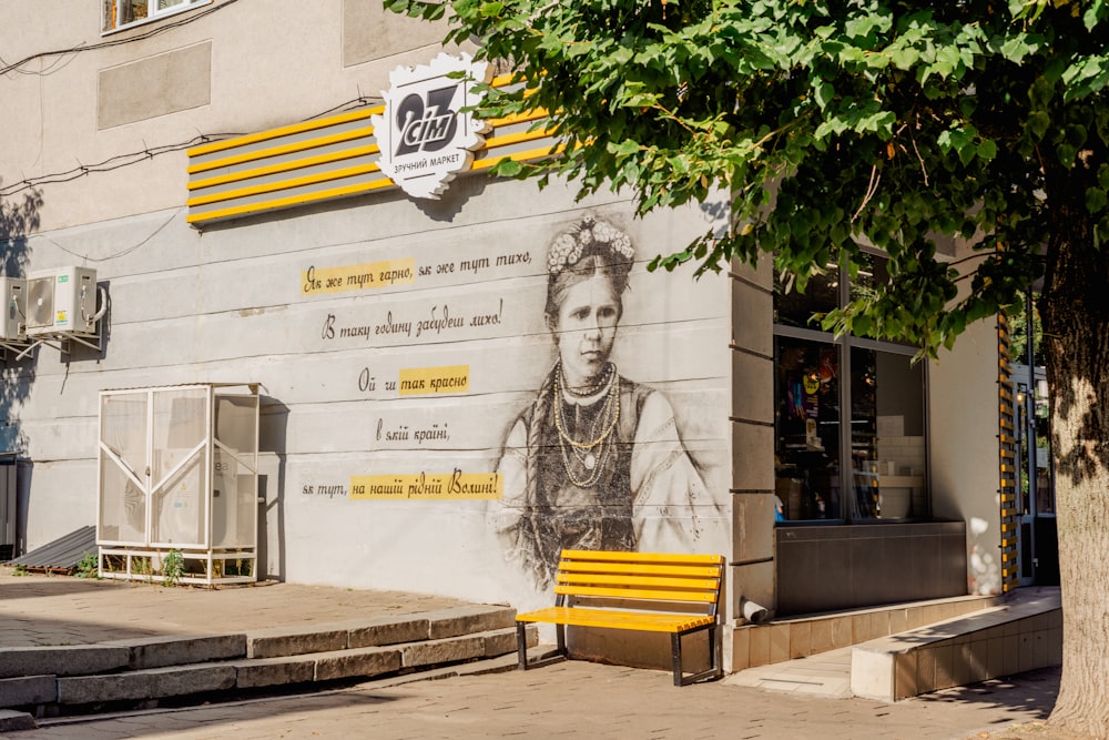 a yellow bench sitting in front of a building