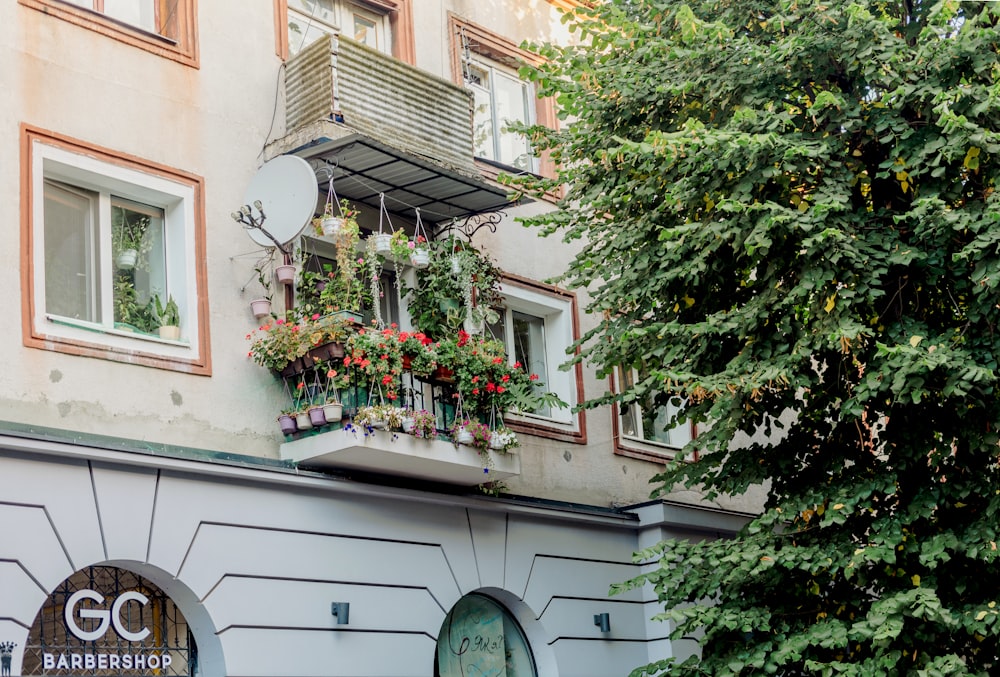 a building with a balcony with flowers on it