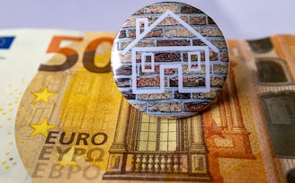 a button sitting on top of a pile of money
