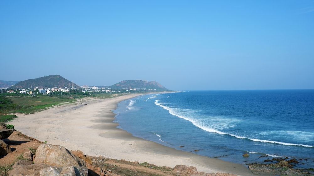 a view of a beach and the ocean from a hill