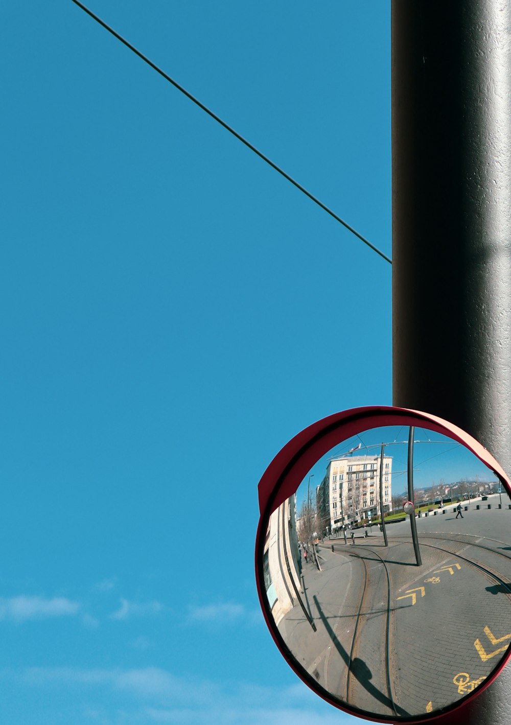 a side view mirror on a pole on a street