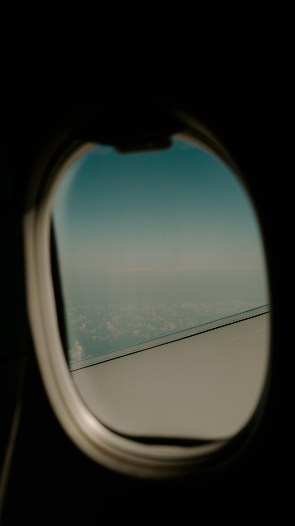 a view of the wing of an airplane through a window