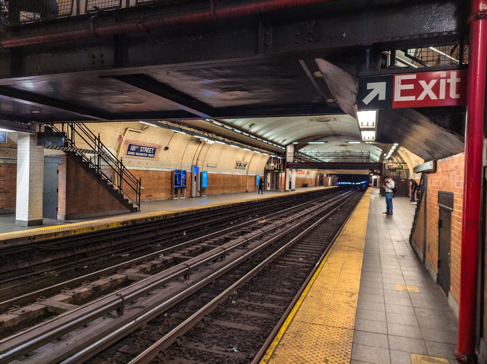 a train station with a train on the tracks