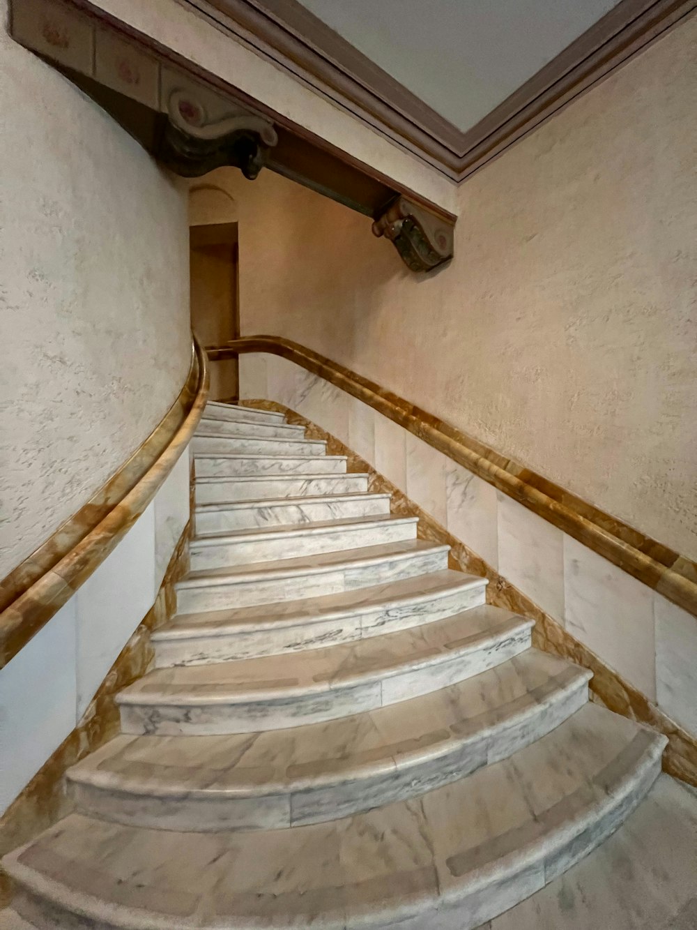 a set of marble stairs leading to a second floor
